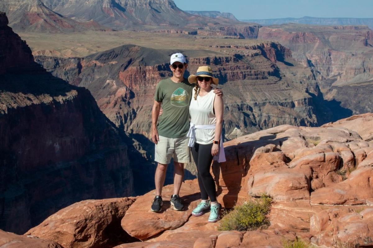 John Mulcahy and family member posed in a scenic natural area.