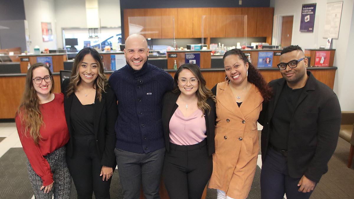 Cesar Alejandro Roman Gonzalez (third from left, in navy sweater) with his Route 4 branch team.