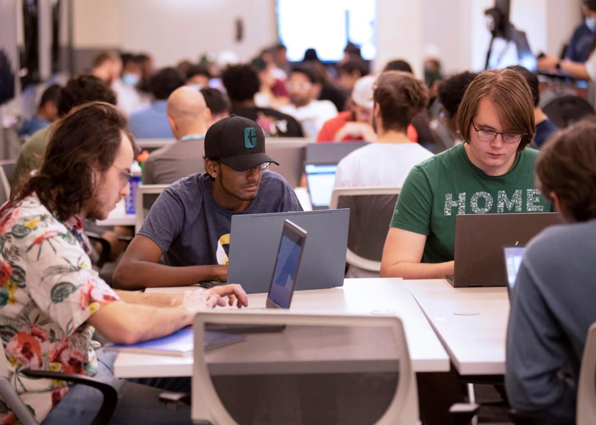 group of students working on laptops