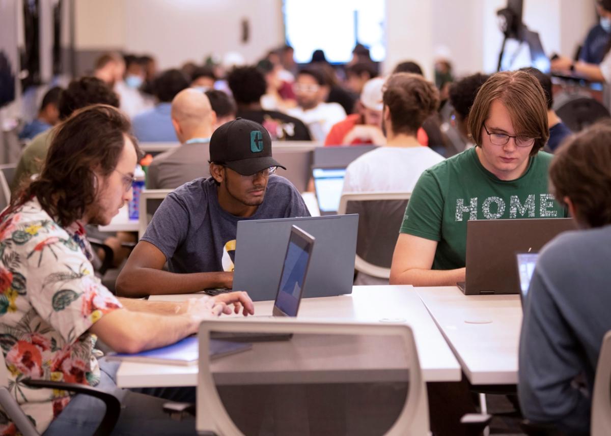 group of students working on laptops 