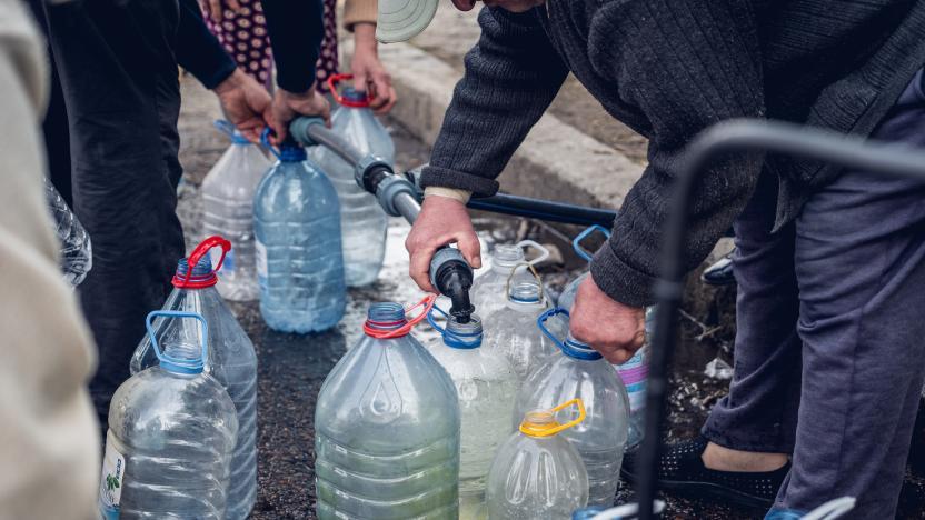 People filling up bottles of water