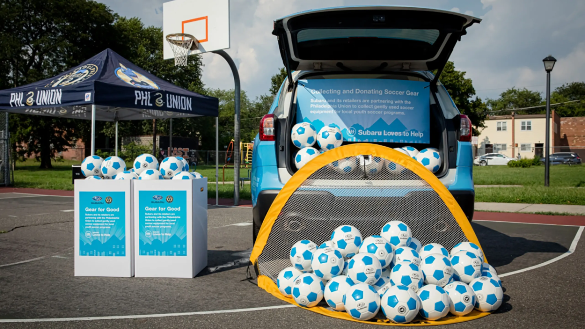 Lots of soccer balls displayed outside a Subaru Loves to Help Event