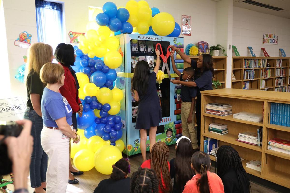 People cutting a ribbon