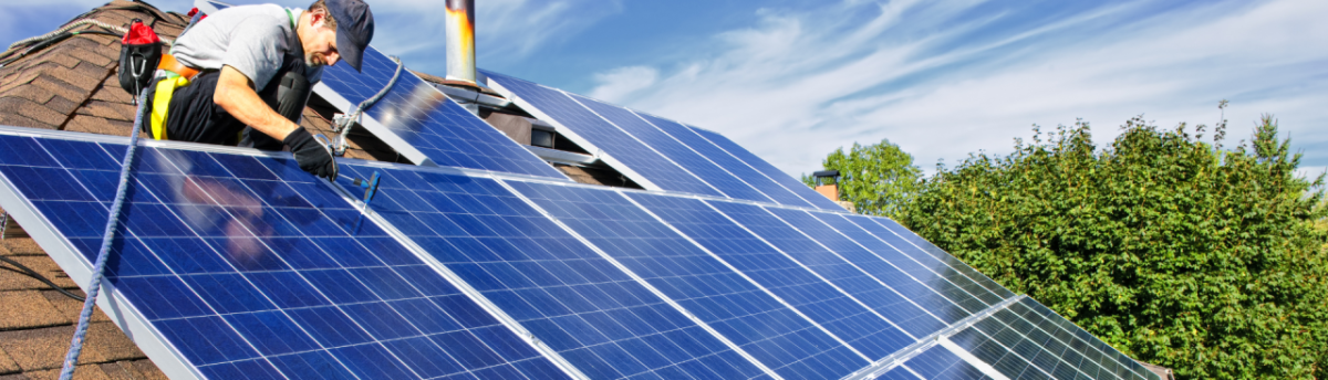 Construction worker installing solar panels