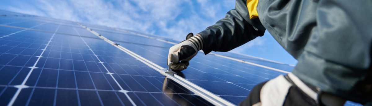 person working on a solar panel