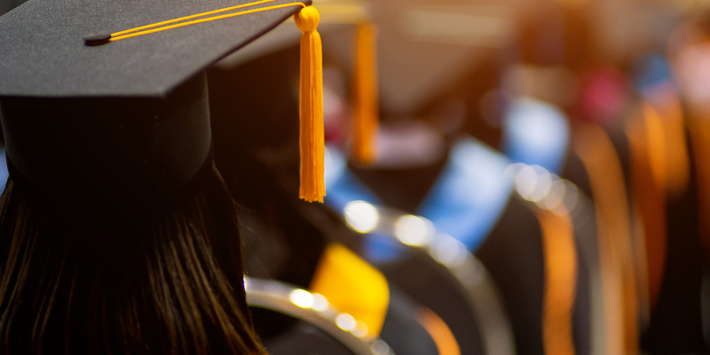 Wesco VOLT Scholarship program. Graduate shown in cap and gown.