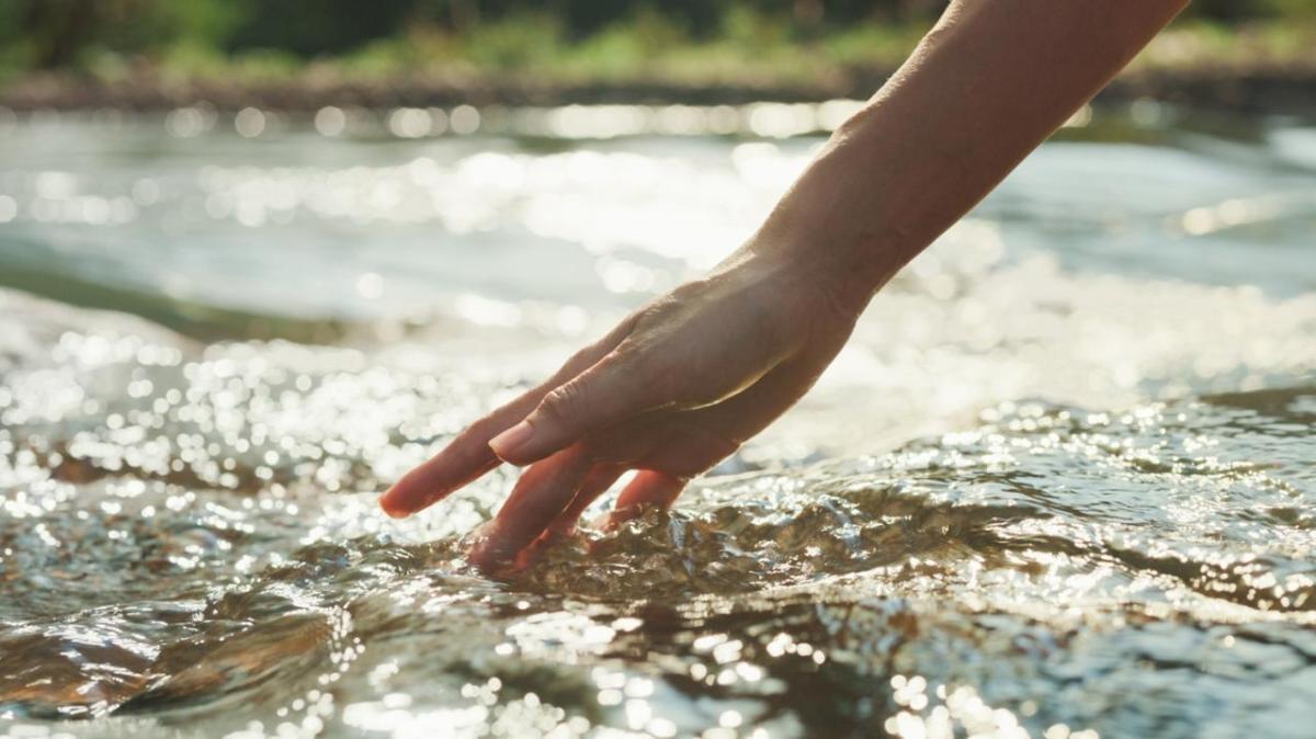 Hand touching water