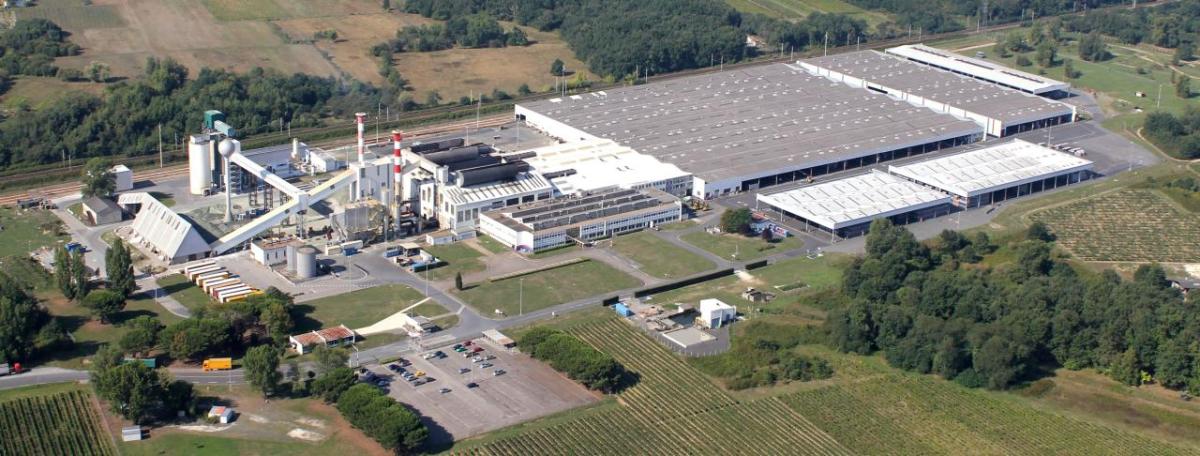 Aerial view of a large building with industrial features.