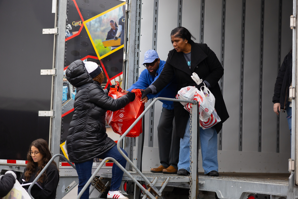 Volunteers handing off presents