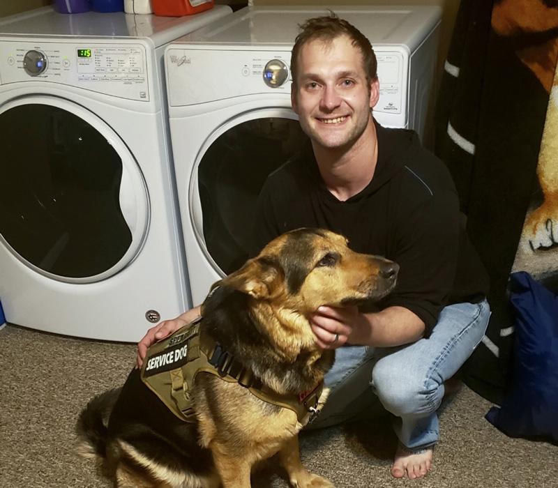 Scott Spearitt with his service dog and new Whirlpool washer and dryer
