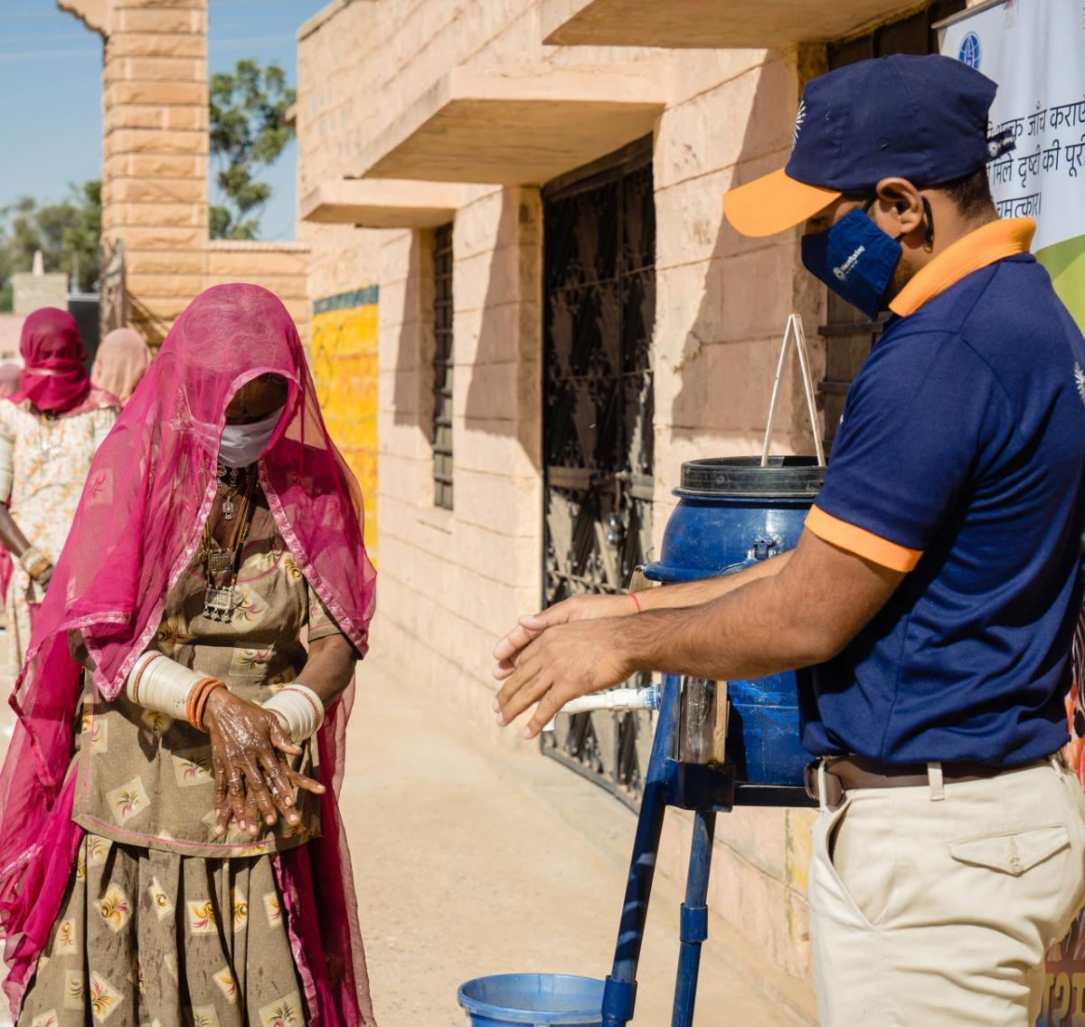 Dai Devi, a weaver in rural Barmer, Rajasthan, washing her hands at a handwashing station provided by VisionSpring. Hand hygiene to prevent the spread of COVID-19 is a core pillar of VisionSpring’s emergency response.