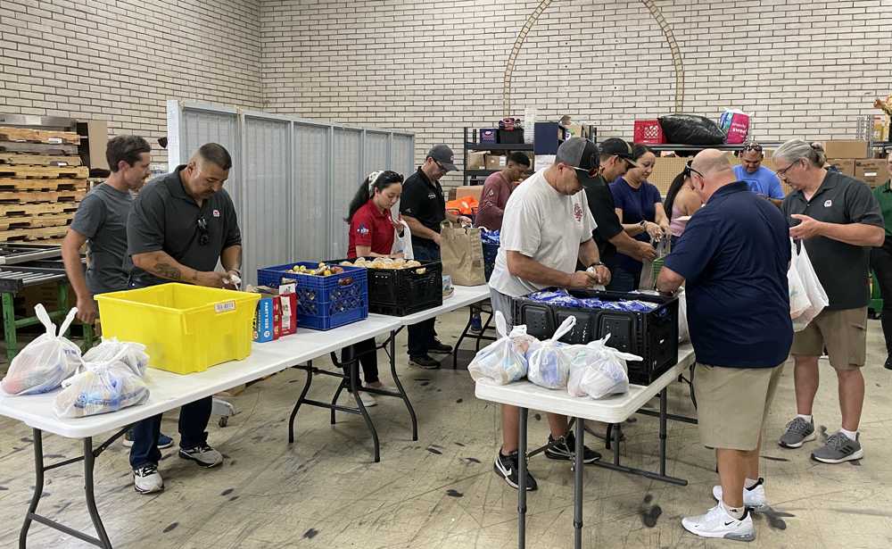 Volunteers packing food bags for homeless individuals and other people in need across the city.