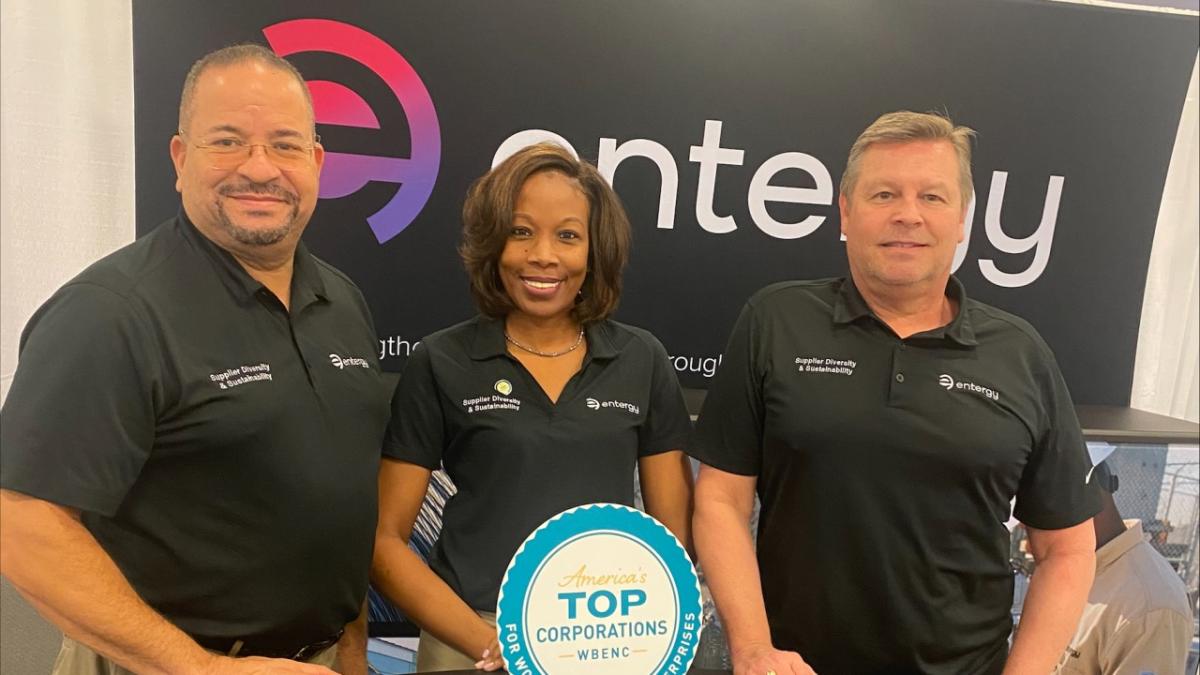 From left, Rivers Frederick, Kya Moller and Dan Boren stood in front of the entergy logo at the WBENC conference