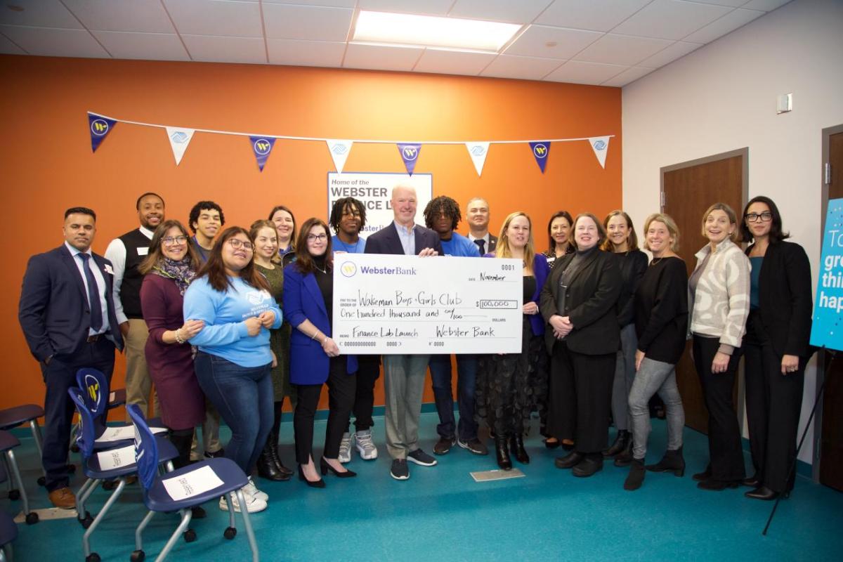 Group celebrating with oversized check