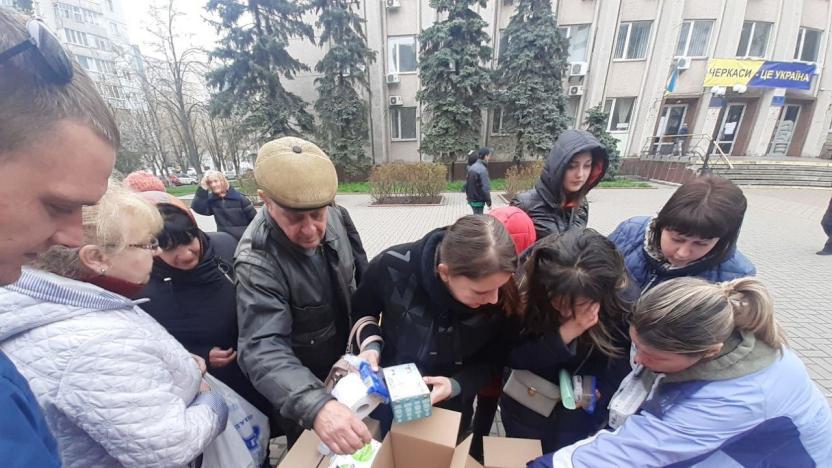 Group of people looking inside boxes of supplies
