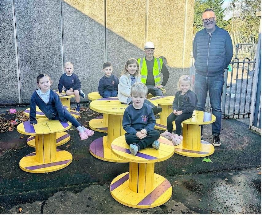 Picture: Children from St Aidan’s with William Story (Maxi) and Graeme Wands (Wesco Anixter) on donated reels.
