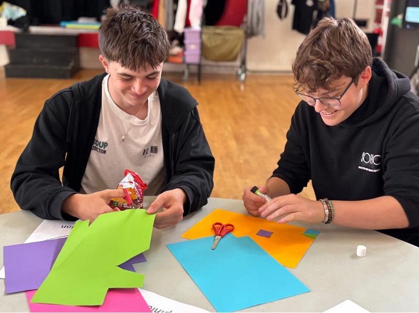 Teenagers shown doing an art project.