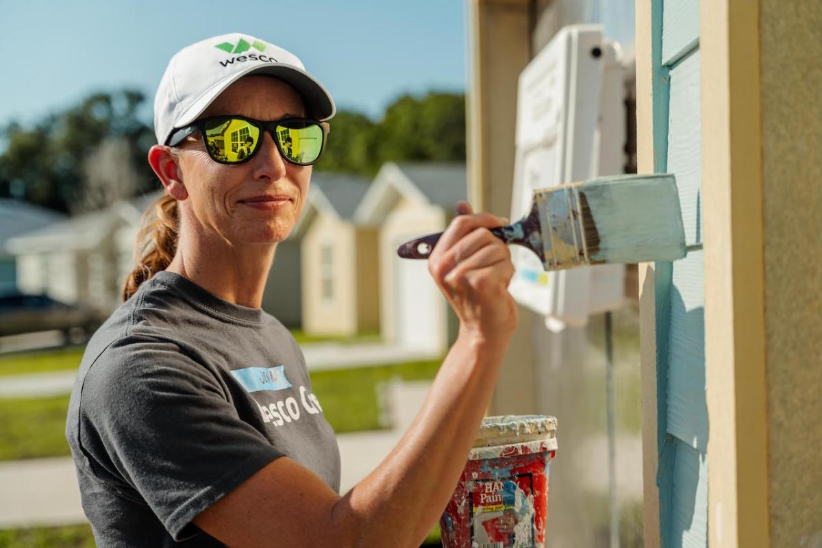 Wesco team member painting the house.