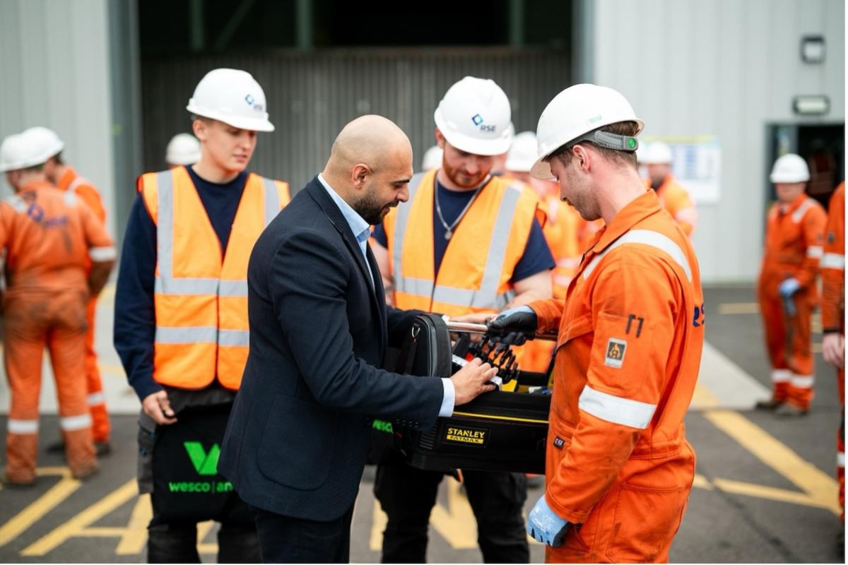 Zubi shaking hands with the apprentices.