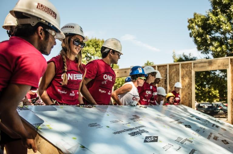 Participants in the fall 2016 Habitat for Humanity build at IU Bloomington raise a wall.
