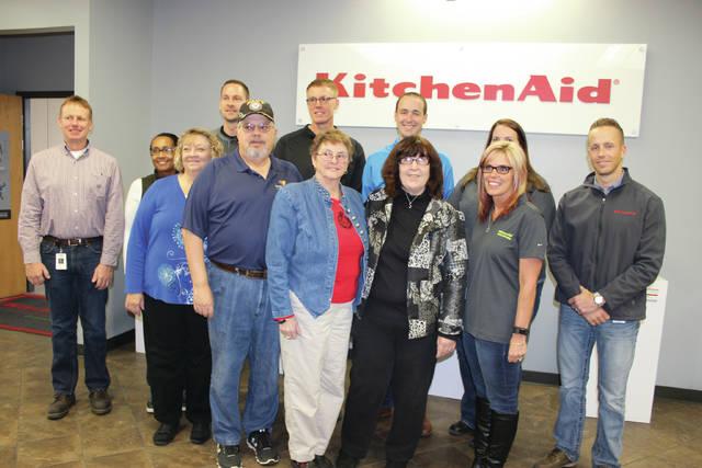 Whirlpool employees stood for a photo op with representatives of local charities Friday afternoon.