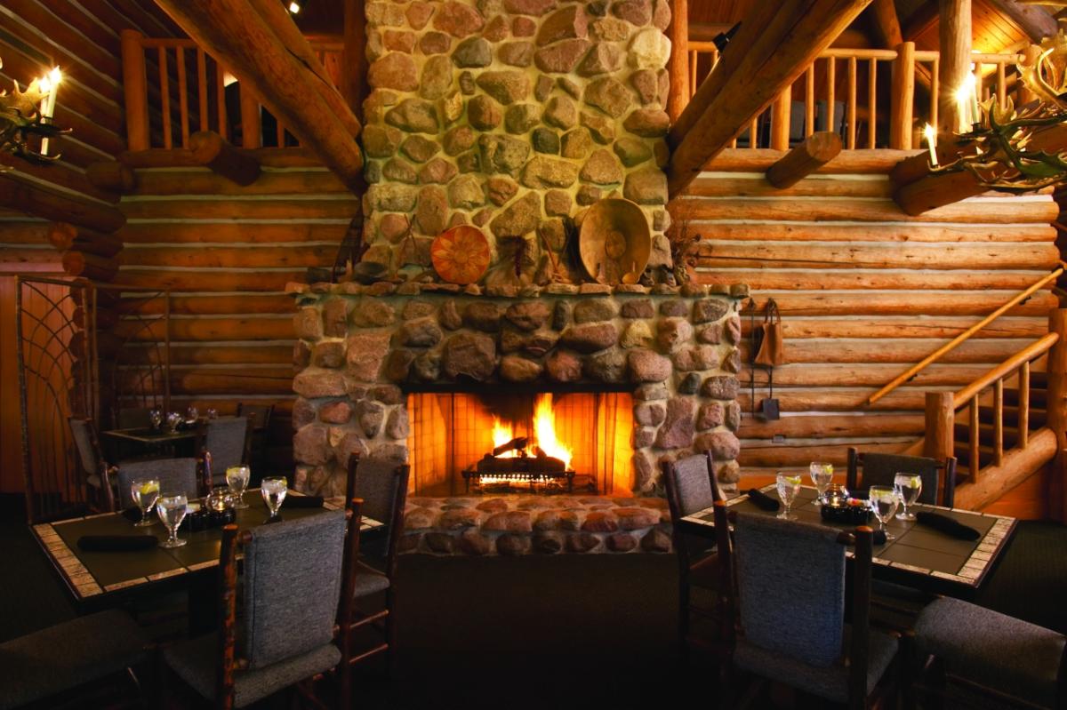 Dining tables in front of a fireplace