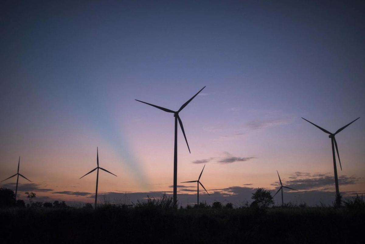 sunset behind wind turbines
