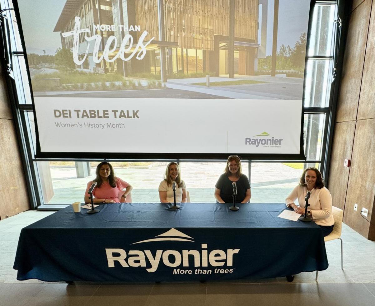 Four women sat at a large table 