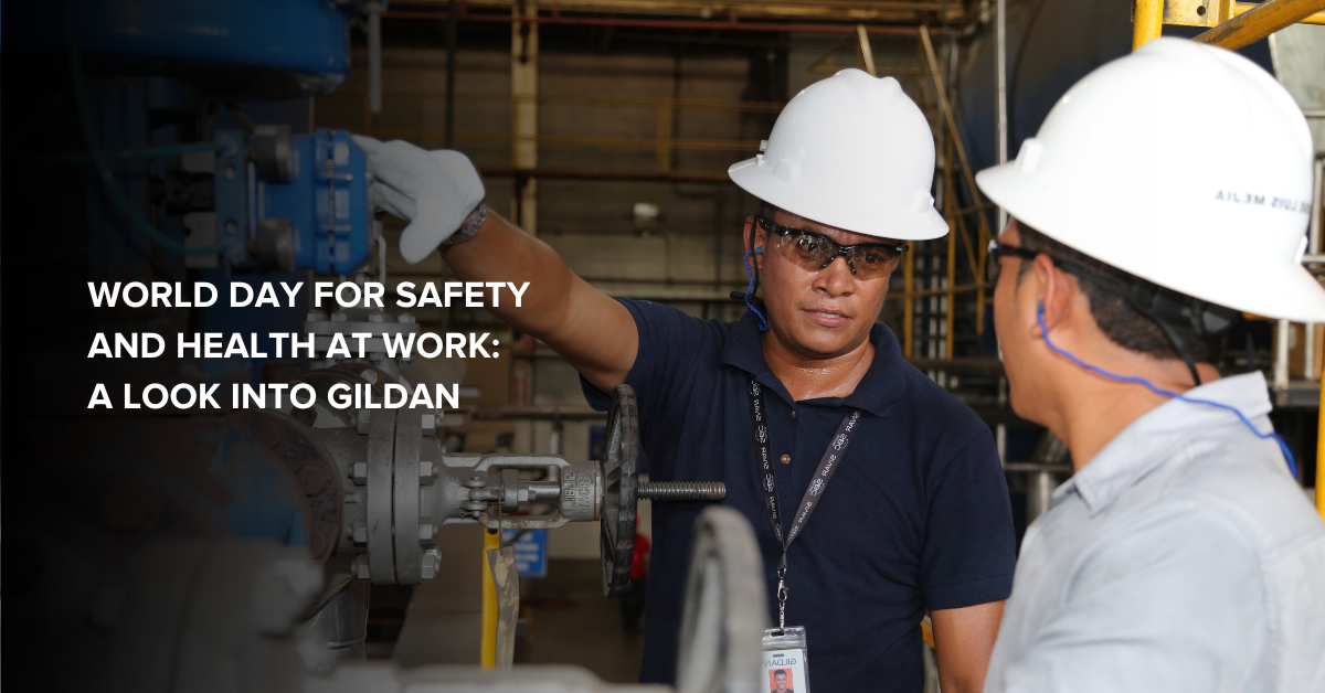 World Day for Safety and Health: A Look into Gildan Two Gildan employees wearing safety equipment, interacting on the factory floor