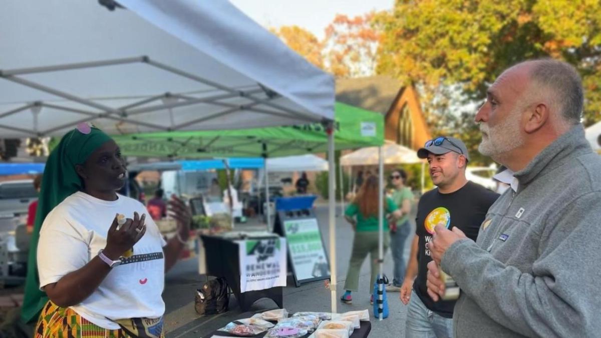 volunteers talking outside under a tent
