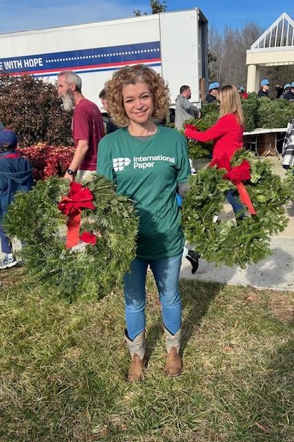 person holding up wreaths