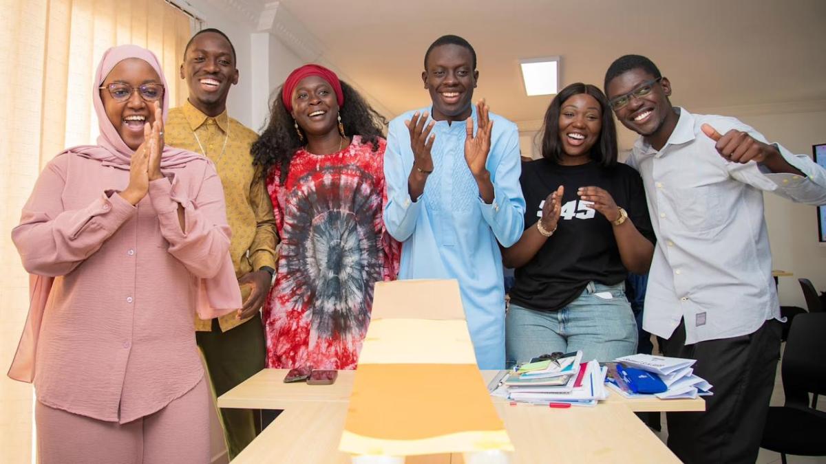 Group of young people clapping and smiling 
