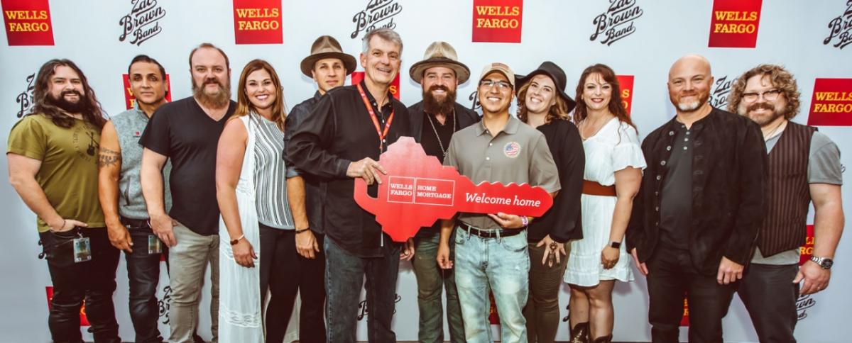Wells Fargo CEO Tim Sloan, Zac Brown, Ramond and Sarah Acosta, and Andrea Dellinger of Military Warriors Support Foundation, celebrate the Acostas' mortgage-free home.