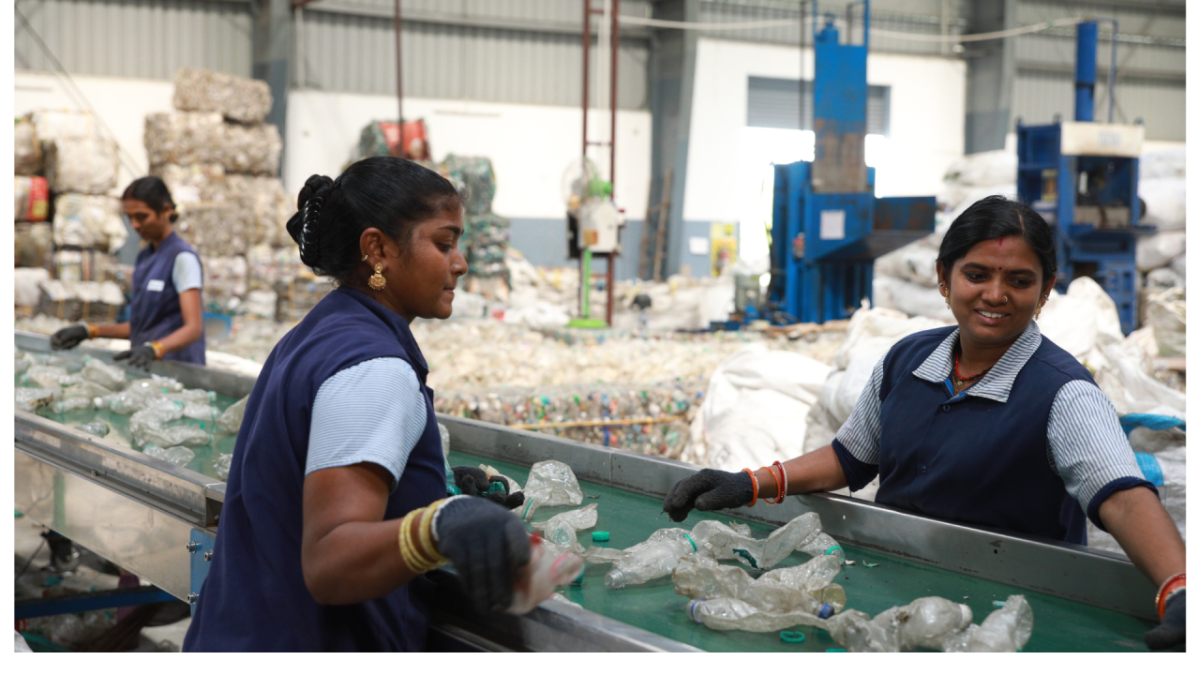 People sorting plastic bottles on a conveyor line.