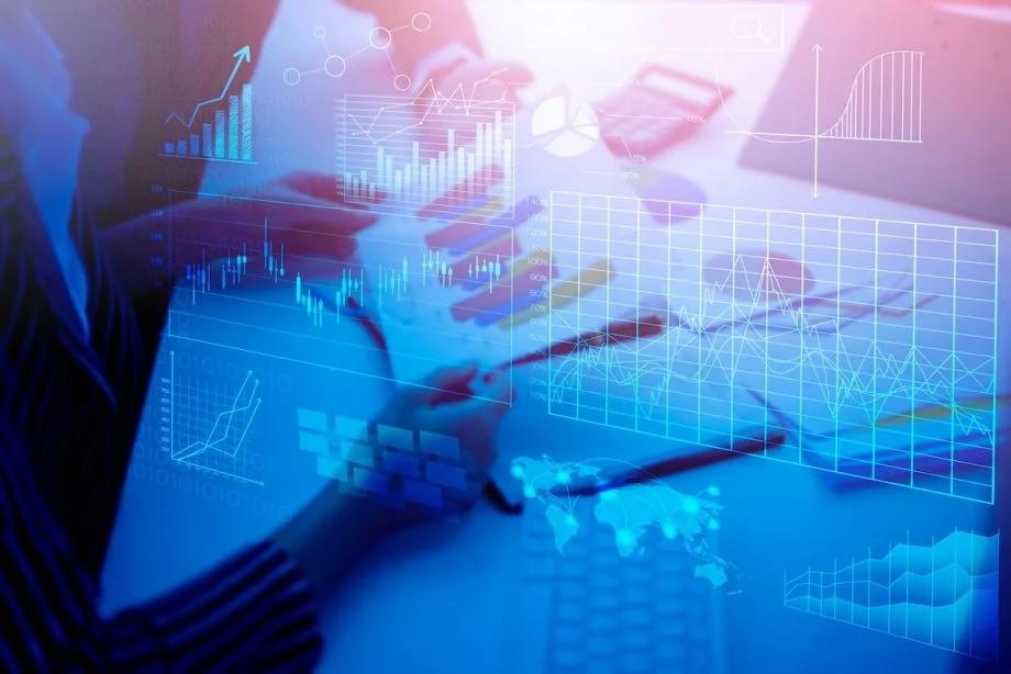 Image courtesy of Next City image of person looking at charts with blue overlay