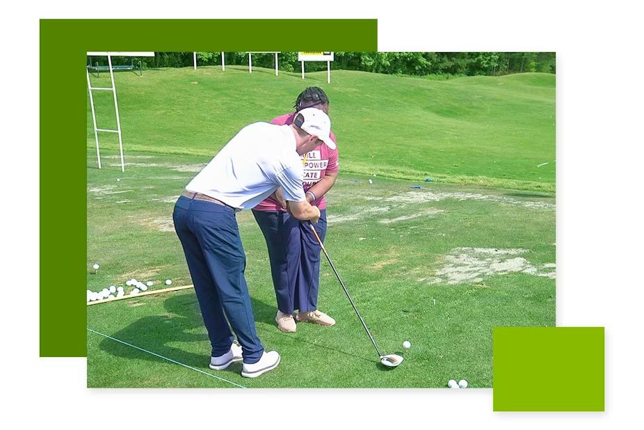 An instructor helping another with a golf club.