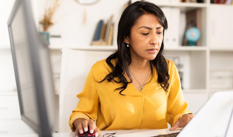 Female worker sitting behind a laptop.