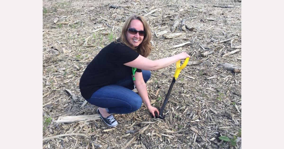 Anna planting a tree.