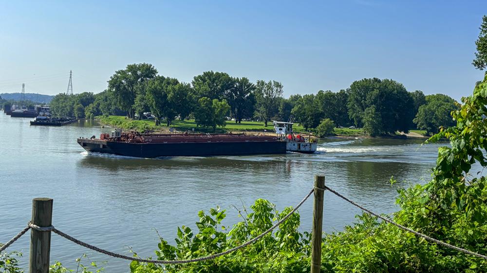 A Marathon Marine vessel makes its way down the Ohio River as volunteers take part in the annual event. " "