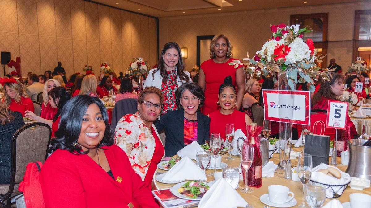 A group of women posed at a table.