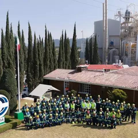 Aerial view of a group of people posed outside, next to a large "Covia" sign.