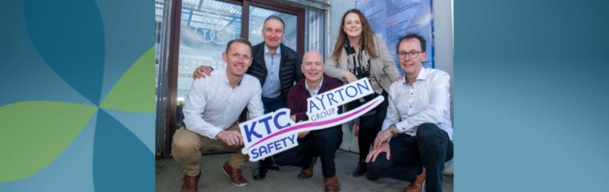 group of 5 posing with KTC Safe and Ayrton Group logos