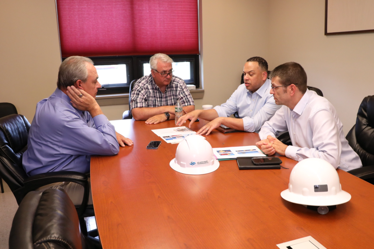 4 people sitting at a meeting