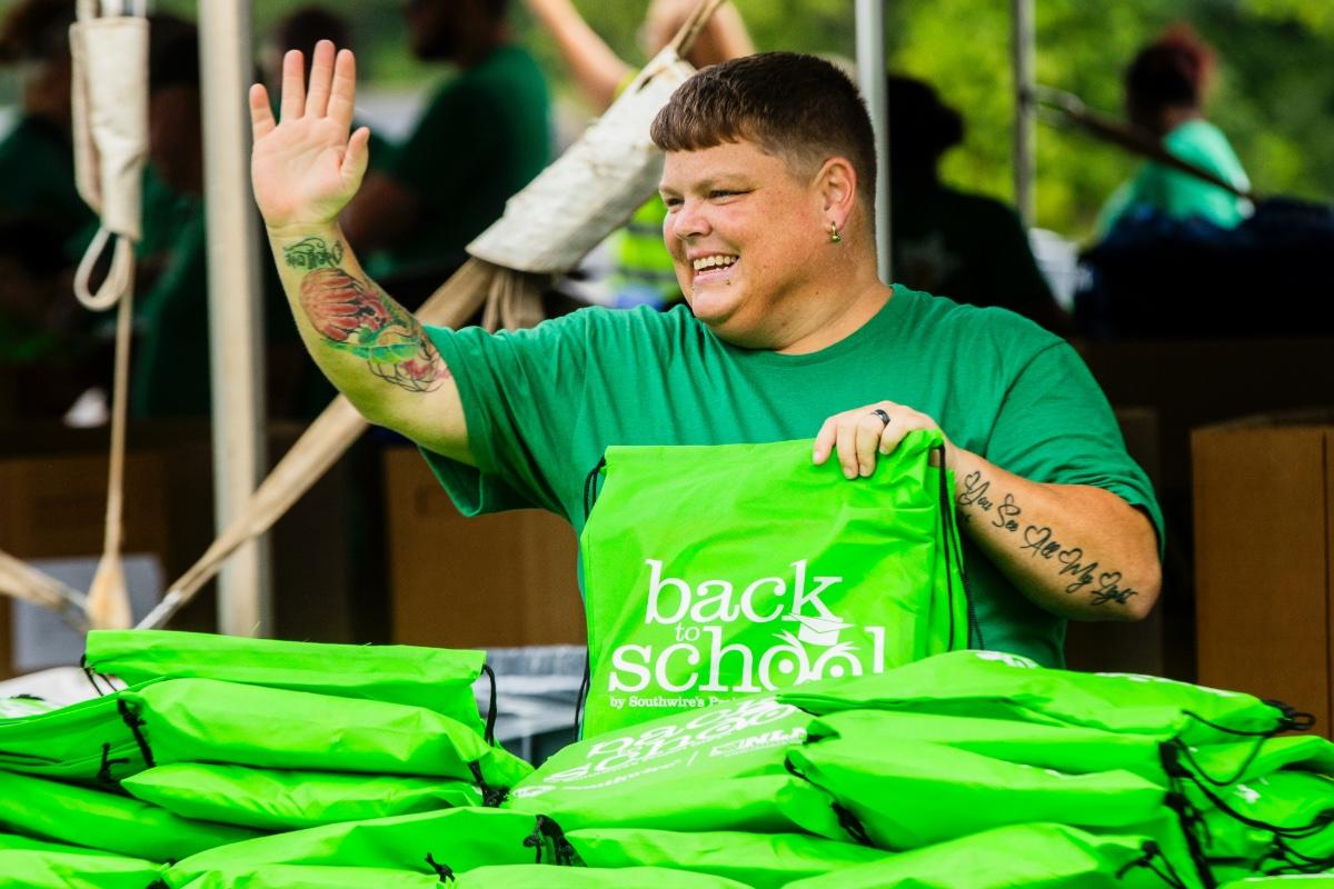 Volunteer waving at passerby