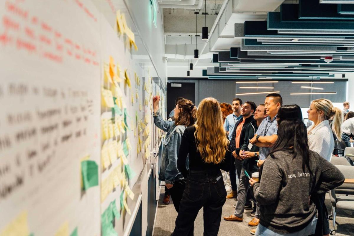 group of students standing at white board 