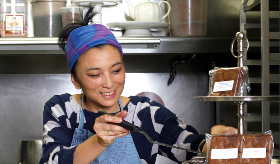 a person uses a spatula on a tiered group of brownies