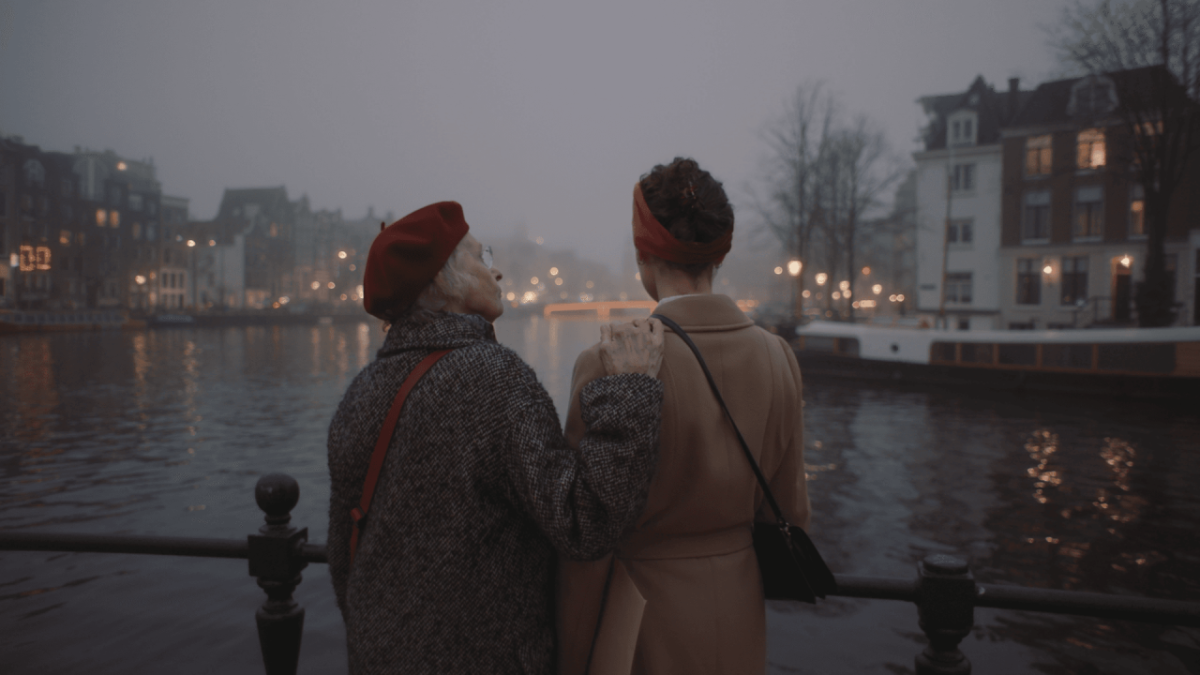 Two people talking while looking out at water