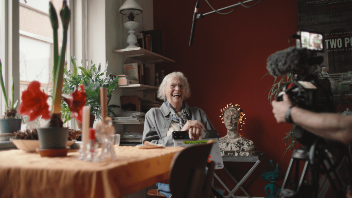 Someone laughing while sitting at a table