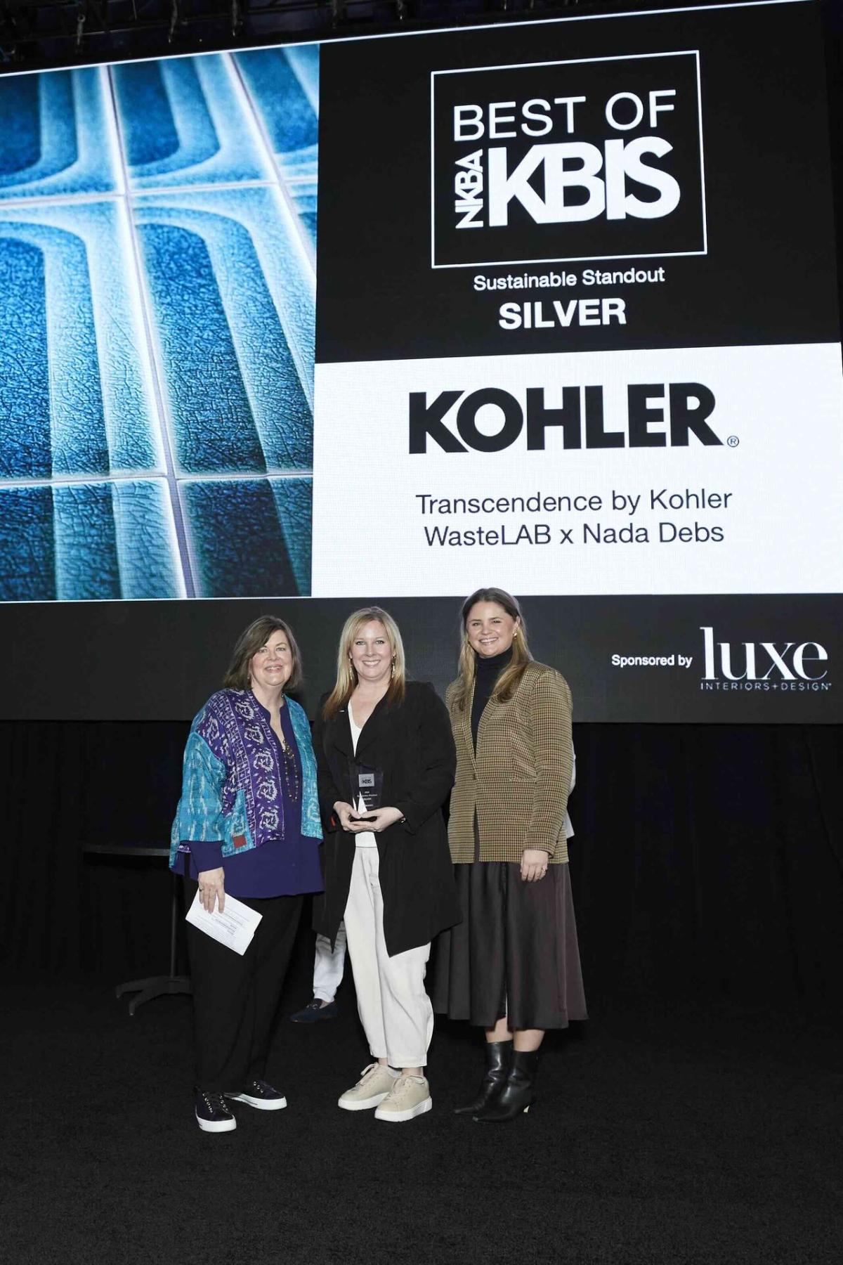 Three people in front of a sign "Best of KBIS Silver. Kohler"