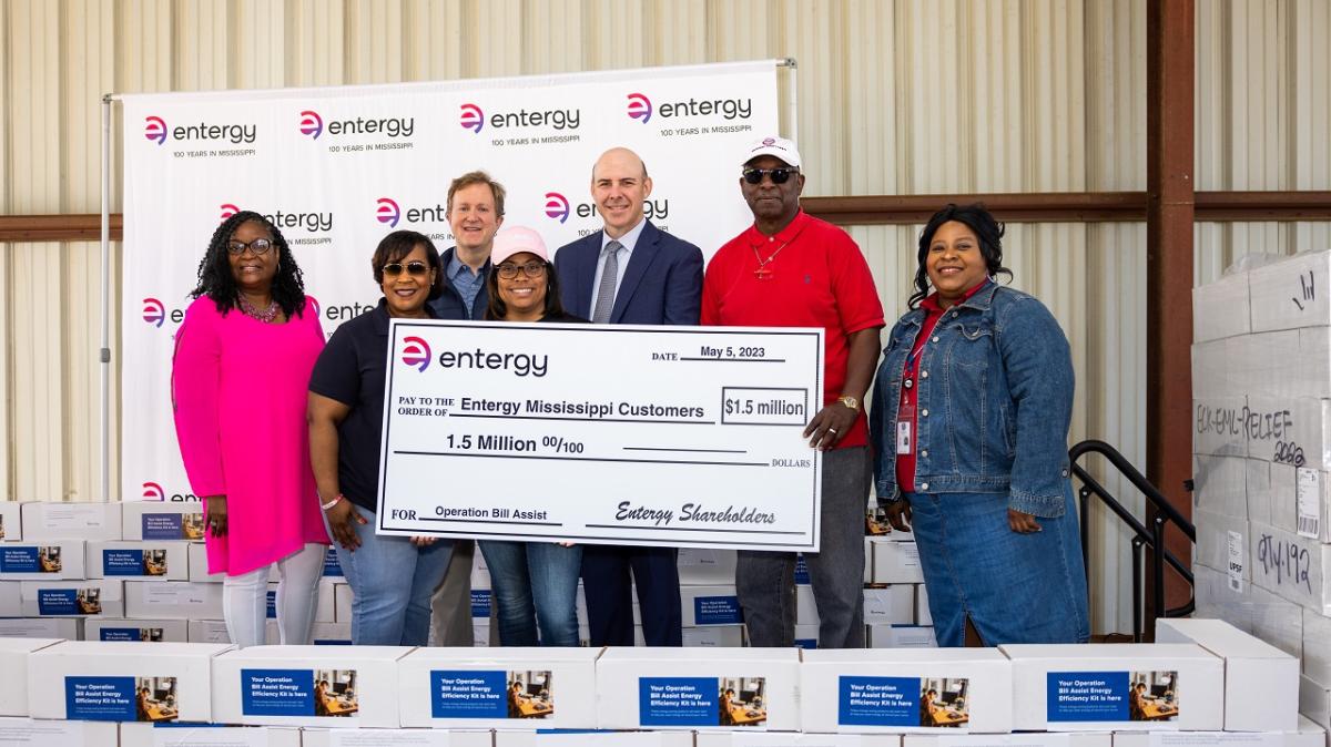 A group of people holding a large check.